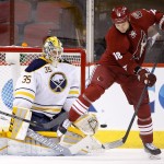 Arizona Coyotes' David Moss (18) creates a screen in front of Buffalo Sabres' Anders Lindback (35), of Sweden, as Coyotes' Connor Murphy scores during the first period of an NHL hockey game Monday, March 30, 2015, in Glendale, Ariz. (AP Photo/Ross D. Franklin)