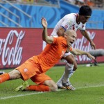 Netherlands' Arjen Robben falls while being held by Costa Rica's Christian Bolanos during the World Cup quarterfinal soccer match at the Arena Fonte Nova in Salvador, Brazil, Saturday, July 5, 2014. (AP Photo/Wong Maye-E)