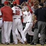  Washington Nationals' Adam LaRoche, second from right, celebrates with his teammates as he approaches home plate after hitting a game-winning solo home run during the 11th inning of a baseball game against the Arizona Diamondbacks, Monday, Aug. 18, 2014, in Washington. The Nationals won 5-4 in 11 innings. (AP Photo/Luis M. Alvarez)