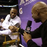 Seattle Seahawks' Richard Sherman shakes hands with Deion Sanders during media day for NFL Super Bowl XLIX football game Tuesday, Jan. 27, 2015, in Phoenix. (AP Photo/David J. Phillip)
