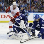 Tampa Bay Lightning goalie Ben Bishop (30) and defenseman Andrej Sustr (62), of the Czech Republic, stop shot by Detroit Red Wings left wing Justin Abdelkader (8) during the third period of Game 7 of a first-round NHL Stanley Cup hockey playoff series Wednesday, April 29, 2015, in Tampa, Fla. The Lightning won the game 2-0. (AP Photo/Chris O'Meara)