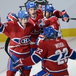 Montreal Canadiens' Daniel Briere (48) celebrates with teammates Michael Bournival (49), Mike Weaver (43) and Dale Weise (22) after scoring against the Tampa Bay Lightning during first period National Hockey League Stanley Cup playoff action on Tuesday, April 22, in Montreal. (AP Photo/The Canadian Press, Ryan Remiorz)