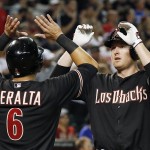 Arizona Diamondbacks' Mark Trumbo, right, celebrates his three-run home run against the St. Louis Cardinals with teammate David Peralta (6) during the seventh inning of a baseball game Saturday, Sept. 27, 2014, in Phoenix. (AP Photo/Ross D. Franklin)