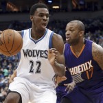 Minnesota Timberwolves' Andrew Wiggins, left, drives around Phoenix Suns' P.J. Tucker during the second half of an NBA basketball game, Friday, Feb. 20, 2015, in Minneapolis. The Timberwolves won 111-109. (AP Photo/Jim Mone)