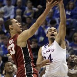 Stanford's Dwight Powell, left, heads to the basket as Kansas' Perry Ellis defends during the second half of a third-round game of the NCAA college basketball tournament Sunday, March 23, 2014, in St. Louis. Stanford won 60-57. (AP Photo/Jeff Roberson)