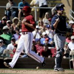 Arizona Diamondbacks' A.J. Pollock, left, scores past Milwaukee Brewers catcher Jonathan Lucroy on a base hit by Gerardo Parra during the second inning of a spring exhibition baseball game in Scottsdale, Ariz., Sunday, March 16, 2014. (AP Photo/Chris Carlson)