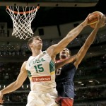 Brazil's Tiago Splitter (15), of the San Antonio Spurs, blocks the shot of United States' Derrick Rose (6), of the Chicago Bulls, during the second half of an exhibition basketball game Saturday, Aug. 16, 2014, in Chicago. The United States won 95-78. (AP Photo/Charles Rex Arbogast)