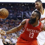 Houston Rockets' James Harden (13) battles Phoenix Suns' Markieff Morris, right, for a loose ball as Suns' Isaiah Thomas (3) looks on during the first half of an NBA basketball game Tuesday, Feb. 10, 2015, in Phoenix. (AP Photo/Ross D. Franklin)