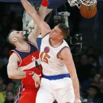Washington Wizards center Marcin Gortat (4) dunks over New York Knicks center Cole Aldrich (45) in the second half of an NBA basketball game at Madison Square Garden in New York, Thursday, Dec. 25, 2014. The Wizards defeated the Knicks 102-91. (AP Photo/Kathy Willens)