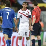 Referee Benjamin Williams, of Australia, gives Costa Rica's Bryan Ruiz a yellow card during the World Cup round of 16 soccer match between Costa Rica and Greece at the Arena Pernambuco in Recife, Brazil, Sunday, June 29, 2014. (AP Photo/Martin Meissner)