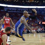 Golden State Warriors' Marreese Speights tries to dish off the ball as he falls to the court with New Orleans Pelicans forward Ryan Anderson, lower left, during the first half of Game 3 of a first-round NBA basketball playoff series in New Orleans, Thursday, April 23, 2015. (AP Photo/Gerald Herbert)