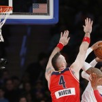 Washington Wizards center Marcin Gortat (4) defends New York Knicks forward Carmelo Anthony (7) in the first half of an NBA basketball game at Madison Square Garden in New York, Thursday, Dec. 25, 2014. (AP Photo/Kathy Willens)
