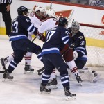 Arizona Coyotes' Oliver Ekman-Larsson (not shown) puts the puck past Winnipeg Jets' goaltender Ondrej Pavelec (31) with Jets' Ben Chiarot (63), Coyotes' Sam Gagner (9), Coyotes' Martin Hanzal (11) and Jets' Adam Lowry (17) in front of the net during first-period NHL hockey game action in Winnipeg, Manitoba, Sunday, Jan. 18, 2015. (AP Photo/The Canadian Press, Trevor Hagan)