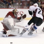 Arizona Coyotes' Mike Smith (41) makes a save on a shot by Colorado Avalanche's Marc-Andre Cliche, as Coyotes' Connor Murphy (5) defends during the first period of an NHL hockey game Tuesday, Nov. 25, 2014, in Glendale, Ariz. (AP Photo/Ross D. Franklin)