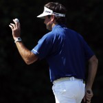 Bubba Watson holds up his ball after putting on the fourth hole during the third round of the Masters golf tournament Saturday, April 12, 2014, in Augusta, Ga. (AP Photo/Matt Slocum)