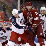 Arizona Coyotes' Martin Hanzal (11), of the Czech Republic, tries to avoid the puck as Columbus Blue Jackets' Dalton Prout (47) and Jack Johnson (7) defend while Blue Jackets' goalie Sergei Bobrovsky (72), of Russia, looks on during the first period of an NHL hockey game Saturday, Jan. 3, 2015, in Glendale, Ariz. (AP Photo/Ross D. Franklin)