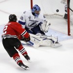 Chicago Blackhawks' Duncan Keith, left, scores past Tampa Bay Lightning goalie Ben Bishop during the second period in Game 6 of the NHL hockey Stanley Cup Final series on Monday, June 15, 2015, in Chicago. (AP Photo/Charles Rex Arbogast)
