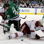 Dallas Stars' center Cody Eakin (20) and Arizona Coyotes' center Antoine Vermette (50) fight for the puck in the first period of an NHL hockey game Wednesday, Dec. 31, 2014, in Dallas. (AP Photo/Sharon Ellman)