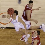 Kentucky's Devin Booker shoots against Wisconsin's Bronson Koenig, top, and Josh Gasser during the second half of the NCAA Final Four tournament college basketball semifinal game Saturday, April 4, 2015, in Indianapolis. (AP Photo/David J. Phillip)