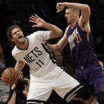 Phoenix Suns' Alex Len (21), of Ukraine, defends against Brooklyn Nets' Brook Lopez (11) during the first half of an NBA basketball game Friday, March 6, 2015, in New York. (AP Photo/Frank Franklin II)
