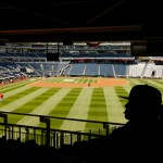 A stadium worker sits above the field before a baseball game between the Washington Nationals and the New York Mets on opening day at Nationals Park, Monday, April 6, 2015, in Washington. (AP Photo/Andrew Harnik)