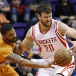 Phoenix Suns' Marcus Morris, left, tips the ball away from Houston Rockets' Donatas Motiejunas, of Lithuania, during the second half of an NBA basketball game Friday, Jan. 23, 2015, in Phoenix. The Rockets defeated the Suns 113-111. (AP Photo/Ross D. Franklin)
