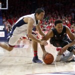 Arizona guard Elliott Pitts, left, and Stanford forward Anthony Brown battle for a loose ball during the first half of an NCAA college basketball game, Saturday, March 7, 2015, in Tucson, Ariz. (AP Photo/Rick Scuteri)