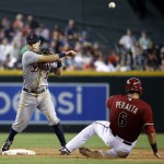 Detroit Tigers' Ian Kinsler (3) forces out Arizona Diamondbacks' David Peralta as he turns a double play on Paul Goldschmidt during the seventh inning of a baseball game, Wednesday, July 23, 2014, in Phoenix. (AP Photo/Matt York)