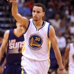Golden State Warriors guard Stephen Curry celebrates after scoring against the Phoenix Suns in the fourth quarter during an NBA basketball game, Monday, March 9, 2015, in Phoenix. (AP Photo/Rick Scuteri)