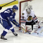 Chicago Blackhawks goalie Corey Crawford, right, blocks a shot by Tampa Bay Lightning left wing Jonathan Drouin during the first period in Game 2 of the NHL hockey Stanley Cup Final on Saturday, June 6, 2015, in Tampa Fla. (AP Photo/John Raoux)