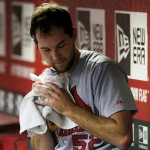 St. Louis Cardinals' Michael Wacha rolls up a towel as he sits in the dugout after pitching against the Arizona Diamondbacks during the second inning of a baseball game Friday, Sept. 26, 2014, in Phoenix. (AP Photo/Ross D. Franklin)