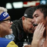 Manny Pacquiao, right, from the Philippines, is helped in his corner between rounds by trainer Freddie Roach during his welterweight title fight against Floyd Mayweather Jr. on Saturday, May 2, 2015 in Las Vegas. (AP Photo/Isaac Brekken)