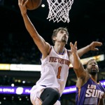 New York Knicks' Alexey Shved (1), of Russia, drives to the basket past Phoenix Suns' Marcus Morris during the first half of an NBA basketball game, Sunday, March 15, 2015, in Phoenix. (AP Photo/Ralph Freso)