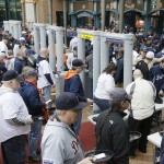 Baseball fans pass through metal detectors before entering Comerica Park for an opening day baseball game between the Detroit Tigers and the Minnesota Twins in Detroit, Monday, April 6, 2015. (AP Photo/Carlos Osorio)
