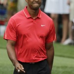 Tiger Woods grimaces after teeing off on the seventh hole during the fourth round of the Masters golf tournament Sunday, April 12, 2015, in Augusta, Ga. (AP Photo/Matt Slocum)