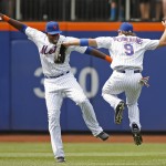 New York Mets left fielder John Mayberry Jr. (44) celebrates with New York Mets center fielder Kirk Nieuwenhuis (9) in the outfield after the Mets 5-3 victory and a sweep over the Arizona Diamondbacks in a baseball game in New York, Sunday, July 12, 2015. Nieuwenhuis hit three home runs in the game. (AP Photo/Kathy Willens)
