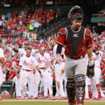 St. Louis Cardinals' Jhonny Peralta (27) is greeted by teammates at home plate after hitting a walk-off solo home run in the tenth inning during a game between the St. Louis Cardinals and the Arizona Diamondbacks on Monday, May 25, 2015, at Busch Stadium in St. Louis. In the foreground is Diamondbacks catcher Tuffy Gosewisch. (Chris Lee/St. Louis Post-Dispatch via AP)