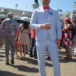 Luke Pascute of Louisville shows his newly-purchased seersucker suit at Churchill Downs before the 141st running of the Kentucky Oaks horse race at Churchill Downs Friday, May 1, 2015, in Louisville, Ky. (AP Photo/Gary Graves)