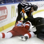 Detroit Red Wings defenseman Danny DeKeyser is examined after being hit with a high stick from Tampa Bay Lightning center Tyler Johnson during the second period of Game 5 of a first-round NHL Stanley Cup hockey playoff series Saturday, April 25, 2015, in Tampa, Fla. Johnson was penalized on the play. (AP Photo/Chris O'Meara)