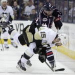 Columbus Blue Jackets' James Wisniewski, top, trips Pittsburgh Penguins' Tanner Glass during the third period of Game 4 of a first-round NHL playoff hockey series on Wednesday, April 23, 2014, in Columbus, Ohio. Wisniewski was penalized on the play. (AP Photo/Jay LaPrete)