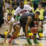 Oregon's Joseph Young, right, grabs the ball by Arizona's Brandon Ashley, left, during the second half of an NCAA college basketball game in the championship of the Pac-12 conference tournament Saturday, March 14, 2015, in Las Vegas. Arizona won 80-52. (AP Photo/John Locher)