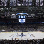 The first puck-drop of the NHL regular season starts the hockey game between the Toronto Maple Leafs and Montreal Canadiens in Toronto on Wednesday, Oct. 8, 2014. (AP Photo/The Canadian Press, Darren Calabrese)