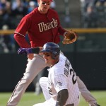  Arizona Diamondbacks second baseman Aaron Hill, back, forces out Colorado Rockies' Troy Tulowitzki at second base on the front end of a double play hit into by Wilin Rosario in the ninth inning of the Diamondbacks' 5-3 victory in a baseball game in Denver on Sunday, April 6, 2014. (AP Photo/David Zalubowski)