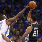  Oklahoma City Thunder forward Serge Ibaka (9) blocks a shot by San Antonio Spurs forward Tim Duncan (21) in the first quarter of Game 4 of the Western Conference finals NBA basketball playoff series in Oklahoma City, Tuesday, May 27, 2014. (AP Photo/Sue Ogrocki)