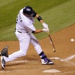 Colorado Rockies' Michael Cuddyer hits a three-RBI double in the eighth inning of a baseball game against the Arizona Diamondbacks, Friday, Sept. 19, 2014, in Denver. (AP Photo/Chris Schneider)