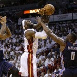  Miami Heat's LeBron James, center, is fouled by Charlotte Bobcats' Bismack Biyombo (0) as Bobcats' Chris Douglas-Roberts (55) looks on during the first half in Game 1 of an opening-round NBA basketball playoff series on Sunday, April 20, 2014, in Miami. (AP Photo/Lynne Sladky)
