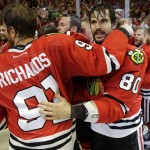 Chicago Blackhawks center Brad Richards (91) and center Antoine Vermette (80) celebrate after defeating the Tampa Bay Lightning in Game 6 of the NHL hockey Stanley Cup Final series on Monday, June 15, 2015, in Chicago. The Blackhawks defeated the Lightning 2-0 to win the series 4-2. (AP Photo/Nam Y. Huh)
