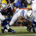 Indianapolis Colts running back Zurlon Tipton (37) scores on a one-yard touchdown run past New England Patriots outside linebacker Dont'a Hightower (54) during the first half of the NFL football AFC Championship game Sunday, Jan. 18, 2015, in Foxborough, Mass. (AP Photo/Julio Cortez)
