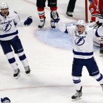 Tampa Bay Lightning's Ondrej Palat and Matt Carle, left, celebrate after a goal by Palat during the third period in Game 3 of the NHL hockey Stanley Cup Final against the Chicago Blackhawks on Monday, June 8, 2015, in Chicago. (AP Photo/Charles Rex Arbogast)