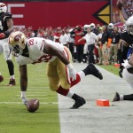 San Francisco 49ers running back Carlos Hyde (28) scores a touchdown against the Arizona Cardinals during the first half of an NFL football game, Sunday, Sept. 21, 2014, in Glendale, Ariz. (AP Photo/Rick Scuteri)
